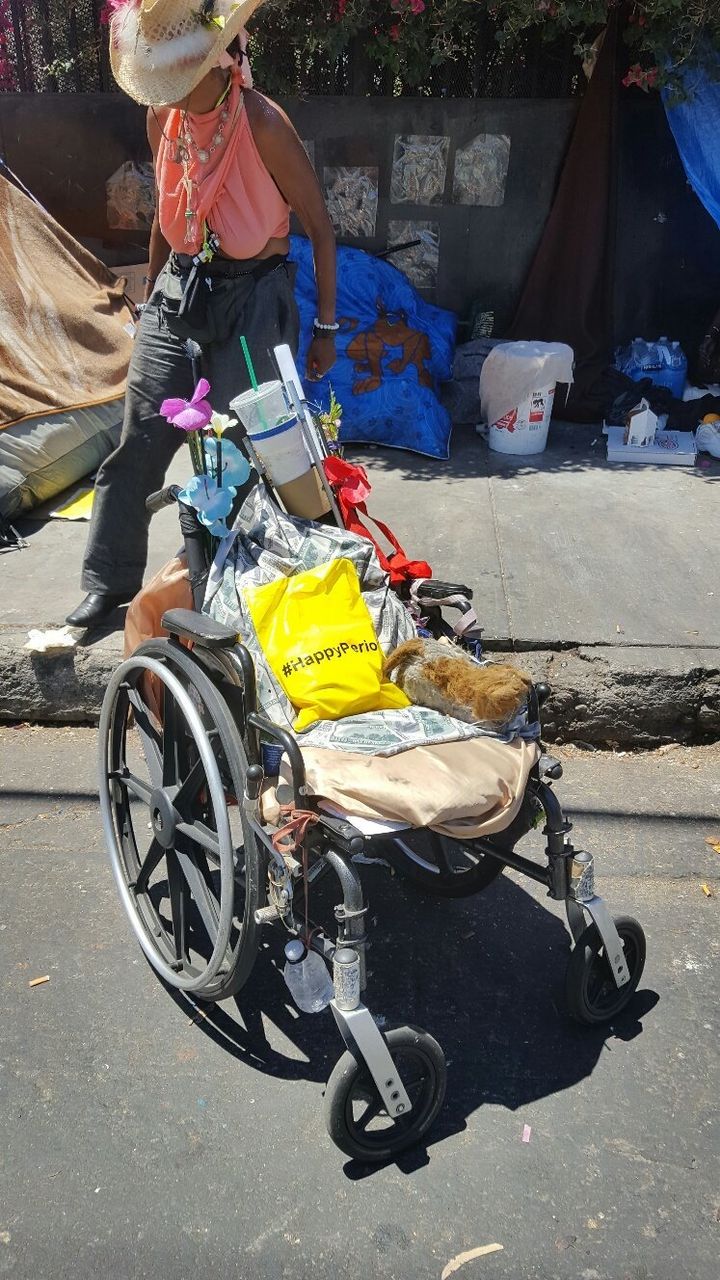 Happy Period bag given to a homeless woman in the Skid Row area of Los Angeles. The woman pictured uses the wheelchair to transport her belongings.