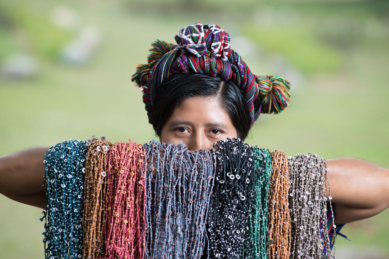 A Guatemalan woman holds up a selection of Wakami jewellery