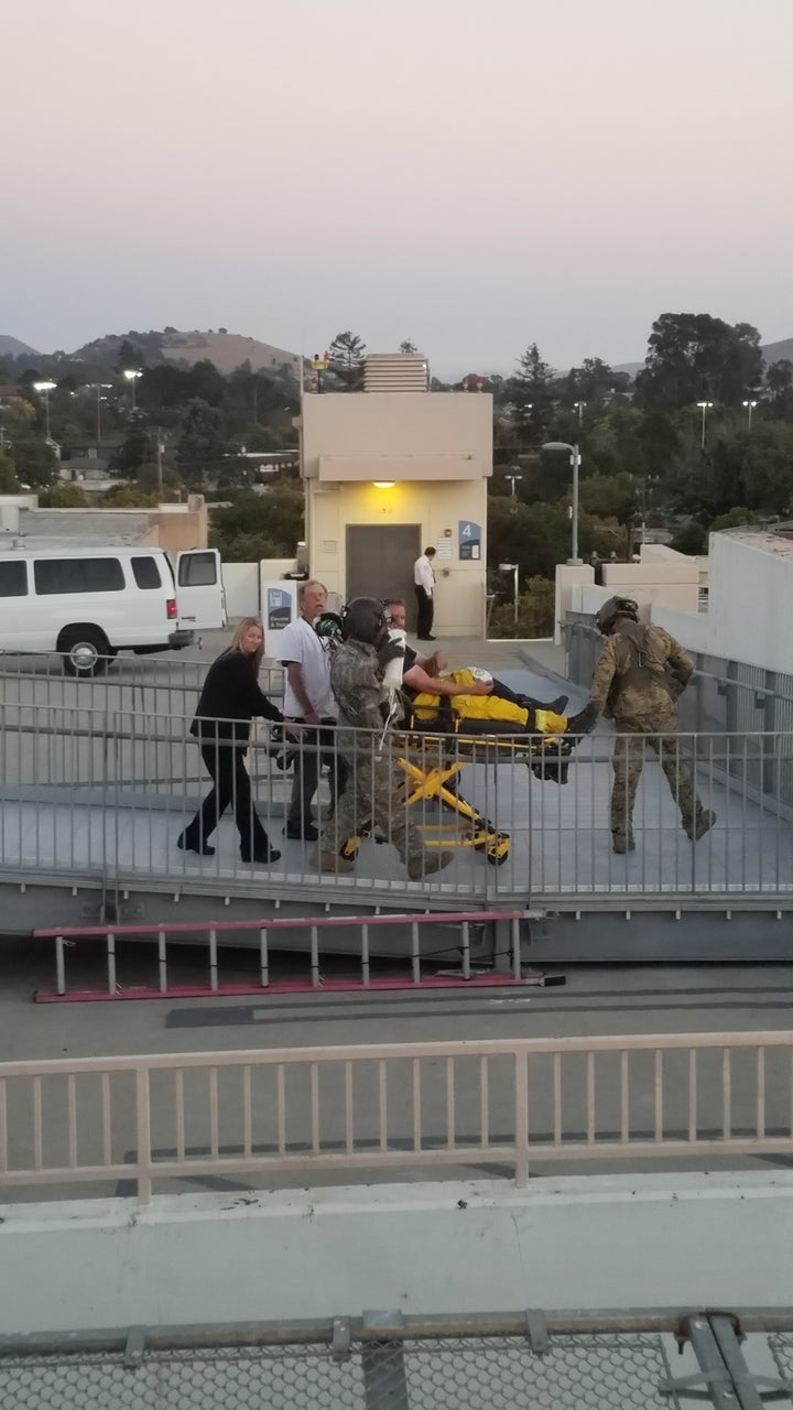 Crew Chief Julian Ross and Medic Greg Proell accompany a firefighter into the hospital.