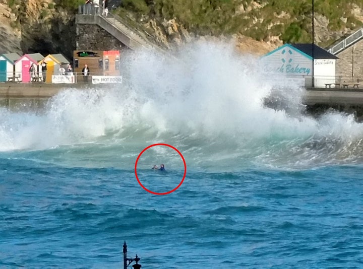 Bruynius holds his daughter out of the water after the pair were swept into the sea