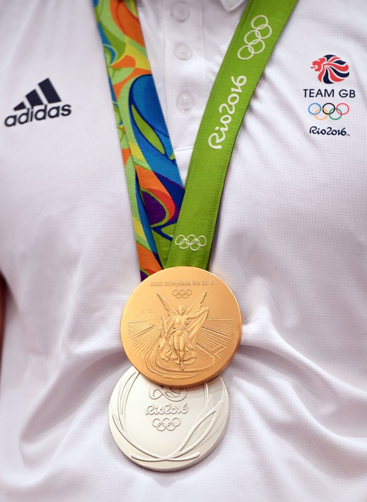 LONDON, ENGLAND - AUGUST 23: Gold medalist Adam Peaty, medal detail, speaks to journalists during the Team GB press conference at the Sofitel, Heathrow Airport on August 23, 2016 in London, England. The 2016 British Olympic Team arrived back to Heathrow on a British Airways flight today having finished second in the medal table at the Rio Olympics. They totalled 67 medals including 27 Gold and 23 Silver in Great Britain's strongest olympic performance in over a century. (Photo by Stuart C. Wilson/Getty Images)