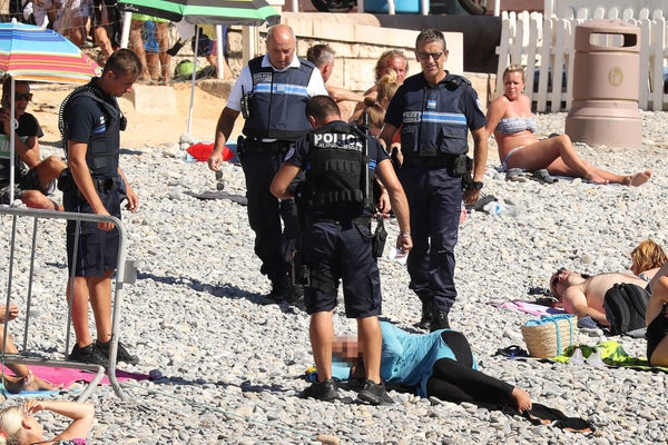 Police fine the first person for wearing a burkini on the Promenade des Anglais beach in Nice, France on August 23, 2016. The