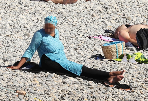 Police fine the first person for wearing a burkini on the Promenade des Anglais beach in Nice, France on August 23, 2016. The