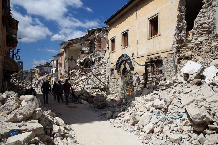 Rescue workers search for survivors in the rubble following an earthquake in Amatrice, Italy, on Wednesday, August 24, 2016.