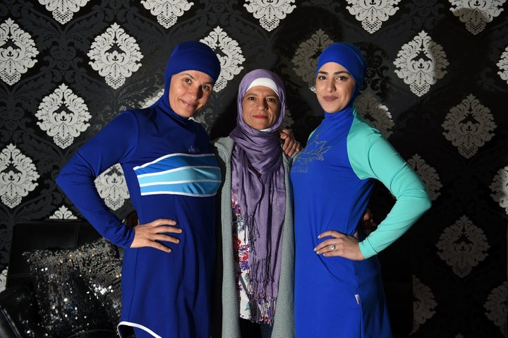 Models clad in burkini swimsuits pose for photos with Australian-Lebanese designer Aheda Zanetti (C) in western Sydney on Aug. 19.