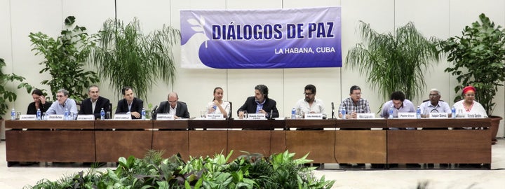 Members of the Colombian government's and FARC leftist guerrilla's delegations and guarantors for peace talks attend a press conference at the Convention Palace in Havana, on August 12, 2016.