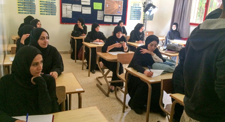Behind the scenes, Muna's classmates wearing traditional hijabs. 
