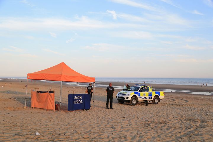 Police officers at the scene in Camber Sands, near Rye, East Sussex 