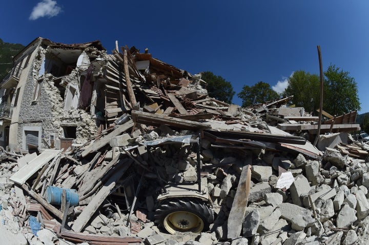 PESCARA DEL TRONTO, ITALY - AUGUST 25: Rubble surrounds a damaged building on August 25, 2016 in Pescara del Tronto, Italy.