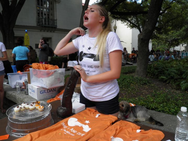 University of Texas student Rosie Zander holds a sex toy at a protest against a state law that allows for guns in classrooms at college campuses, in Austin, Texas.