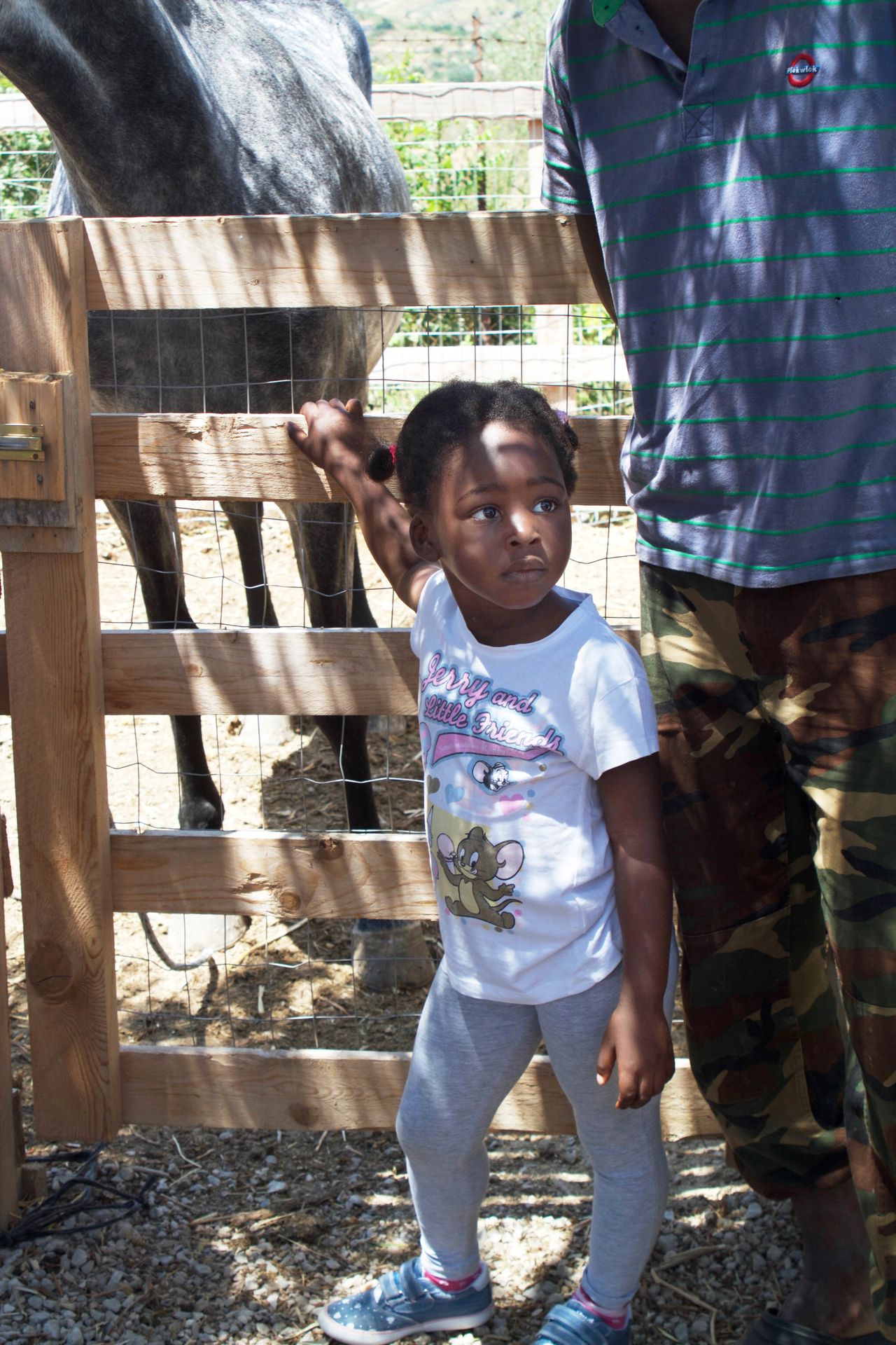 Prospery Sesay, 3, hangs out on the farm while her dad sells produce he picked in the Palermo market.