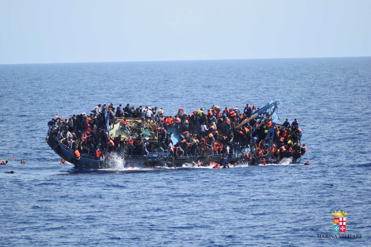 Refugees and migrants are seeing jumping from a capsizing boat in the middle of the Mediterranean on May 25, 2016.