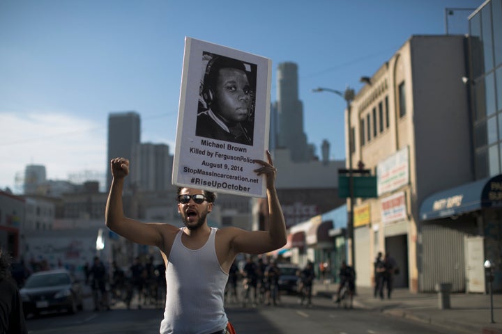 A protester holds a poster showing 18-year-old Michael Brown, who was killed by Ferguson police in 2014. 