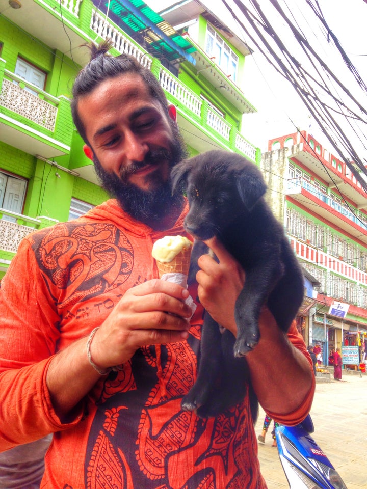 Feeding puppies in Nepal, overly bearded; 2014