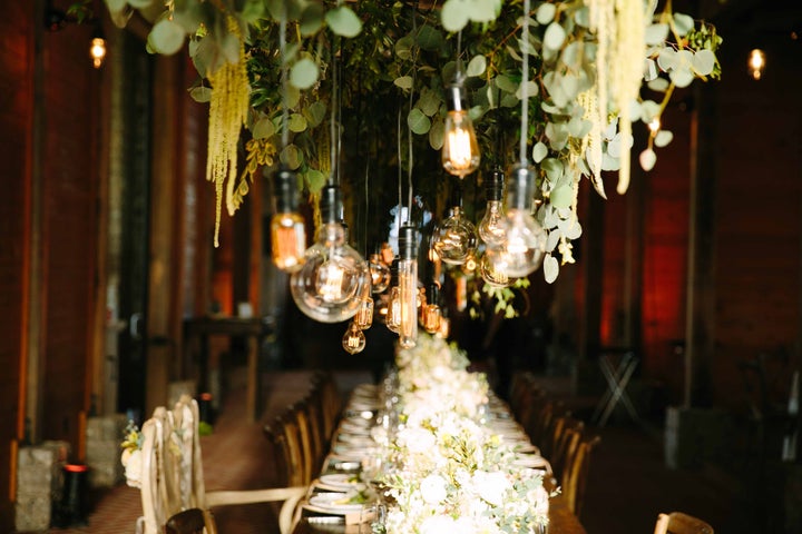 Exposed bulbs hung over the head table at the reception. 