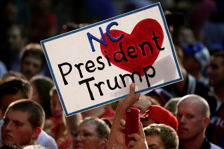 A supporter holds a sign as Republican presidential nominee Donald Trump speaks at a campaign event in Winston-Salem, North Carolina.