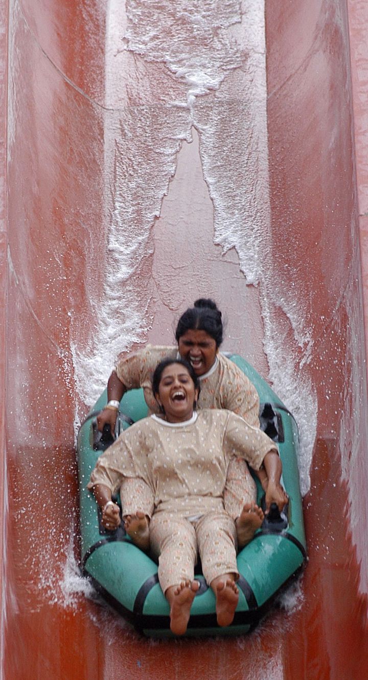 Two women on a water slide in the southern Indian state of Andhra Pradesh.