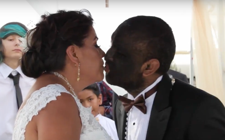 Larry Gomez kisses his bride, Alicia Martinez.