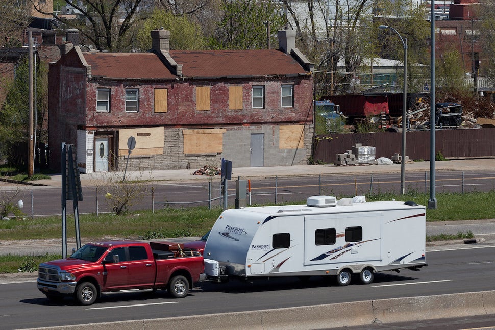 North Riverfront neighborhood of St. Louis. "Tourists hauling mobile homes in a variety of makes and models pass through