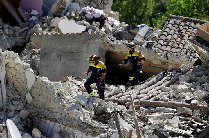 Firefighters inspect damaged houses following an earthquake in Pescara del Tronto, central Italy, August 26, 2016.