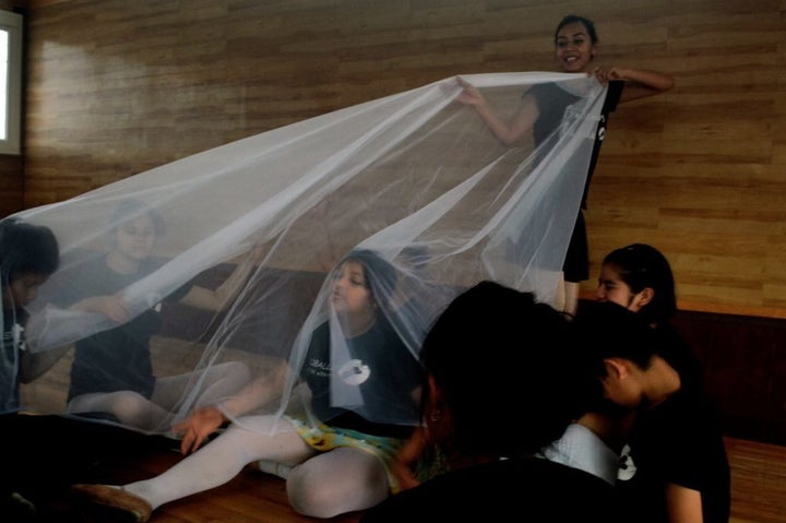 Teacher Lorena Nieva uses translucent fabric in an improvisation and games session in Mexico City to simulate the waves in a new dance inspired by the ocean Alexa 10 sits underneath the fabric.