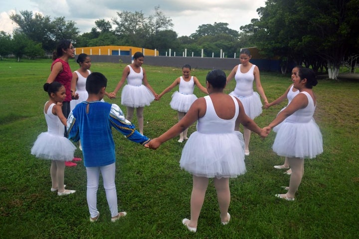 The group forms a celebratory circle following their performance.