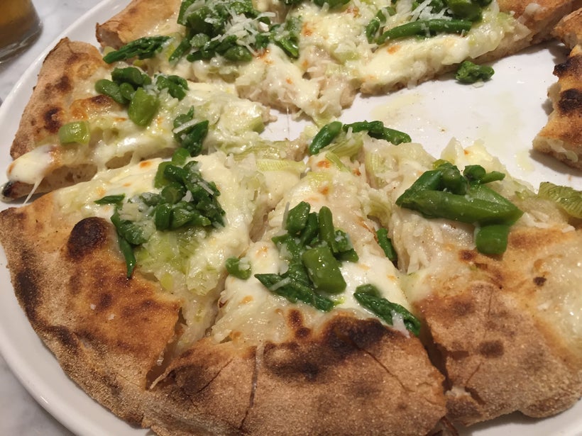 Pizza with asparagus, spring onions, fresh mozzarella, and pecorino cheese.