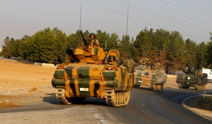 Turkish armoured personnel carriers drive towards the border in Karkamis on the Turkish-Syrian border in the southeastern Gaziantep province, Turkey, August 27, 2016.