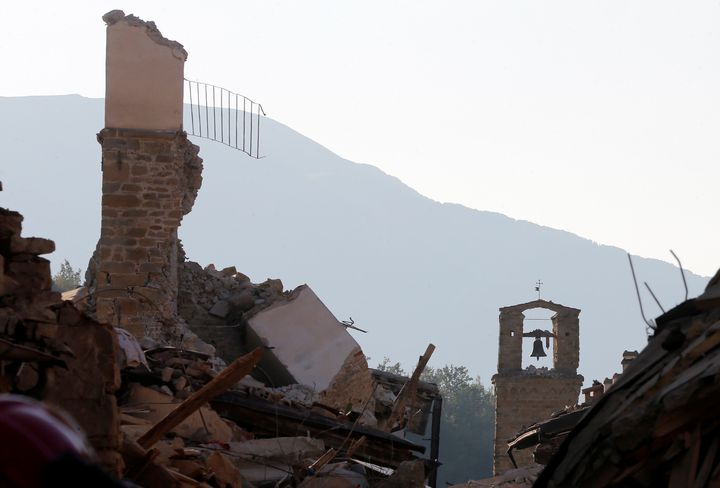 A tower bell is seen standing among Amatrice's ruins on Saturday. At least 290 people were killed from the quake.