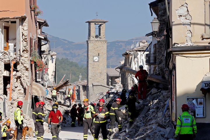 Firefighters and rescuers are seen among the Italian town's ruins. The country has vowed to rebuild. 