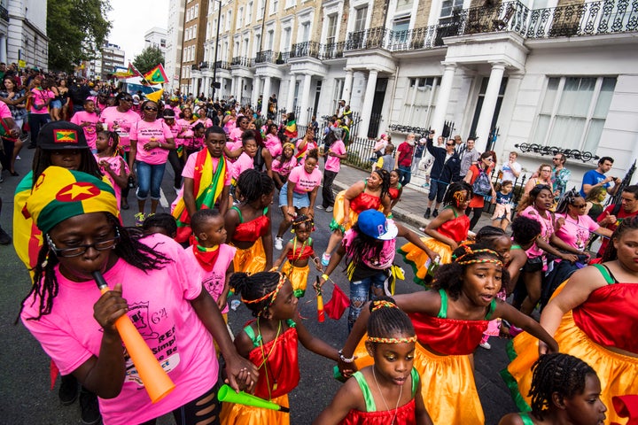 Dancers on the parade route at the Notting Hill Carnival in west London