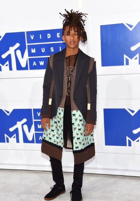 Jaden Smith relied on his go-to formula for looking cool: black jeans, black sneakers, and a coat that does all the talking. We’re not mad at it.