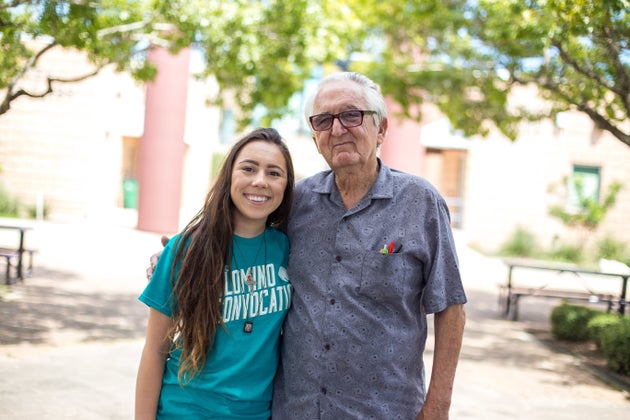 An old man hugging a younger woman.
