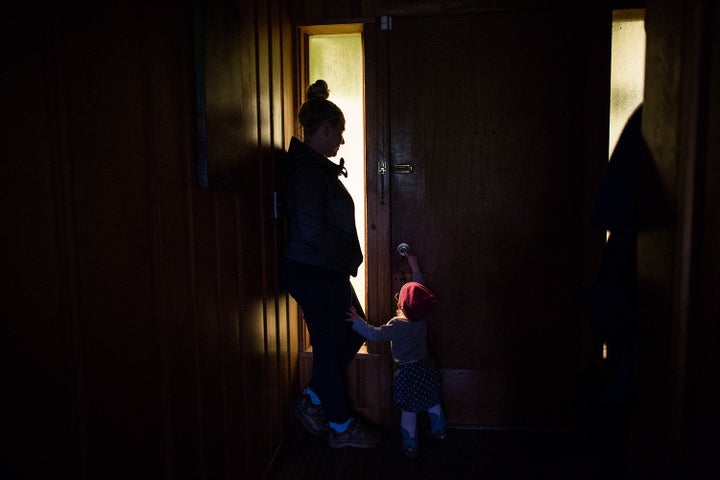 Mary, who farms a small garden for supplemental income with her partner Sam, with her daughter in their home. Hayfork,California.