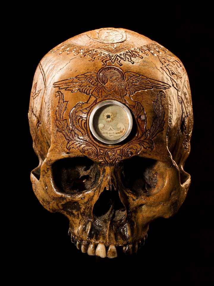 Holy Heart Carvings on this skull pay tribute to Saint Clare de Montefalco, a Catholic abbess who lived in Italy in the late 13th and early 14th centuries. Legend says that when she died in 1308, a small crucifix was found in her heart.