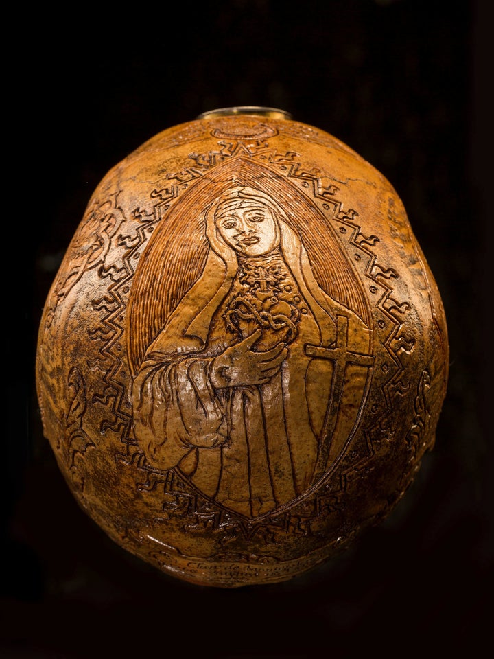 Holy Heart Carvings on this skull pay tribute to Saint Clare de Montefalco, a Catholic abbess who lived in Italy in the late 13th and early 14th centuries. Legend says that when she died in 1308, a small crucifix was found in her heart.