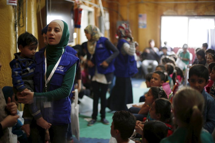 Syrian refugee children play as they wait with their families to register their information at the U.S. processing center for Syrian refugees in Amman, Jordan, April 6.