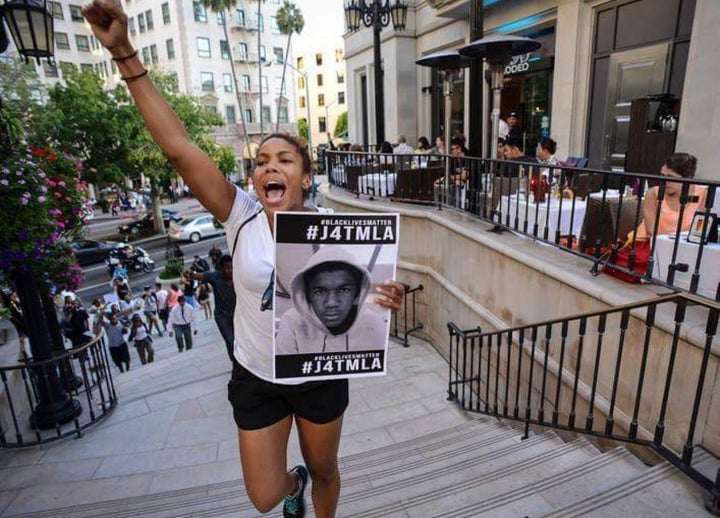 Sharia Lebreton Gulley -- one of the original organizers of Black Live Matters L. A. -- at a Los Angeles rally protesting the acquittal of George Zimmerman. She says forgetting past atrocities brings the risk of excusing or minimizing future ones.