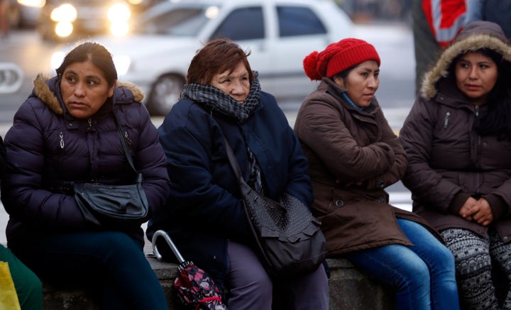 Demonstrators huddle against the cold during a protest over electricity and gas prices in Buenos Aires this year.