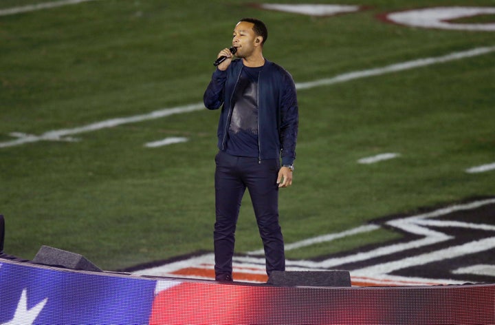 This Jan. 6, 2014 file photo shows John Legend singing the national anthem before the NCAA BCS National Championship college football game between Auburn and Florida State.