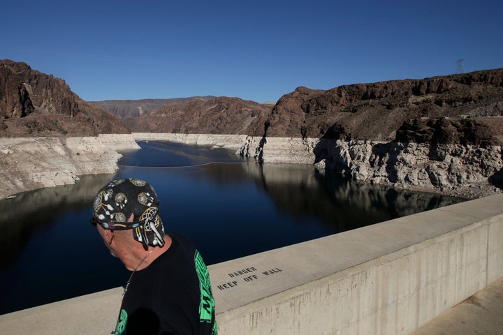 A tourist looks at Lake Mead on the Colorado River near Boulder City, Nev. While the lake's water level has dropped