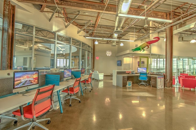 "The bleeding-edge corporate offices of JK Realty. Open-concept floor plan, an arsenal of the newest gen Mac workstations, an