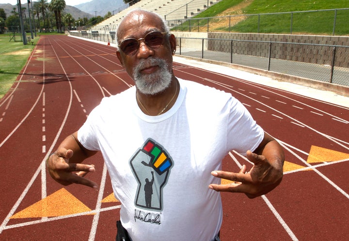 John Carlos, who won bronze in the 1968 Olympics, stands on the campus track at Palm Springs High School, where he is a teacher and counsellor in Palm Springs, California, on July 11, 2012.