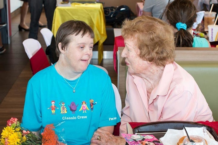 David, wearing her french fry necklace, sits with her mother, Anneliese, during the party.