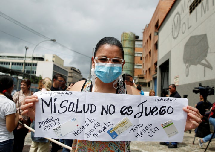 Natasha Suarez, a kidney transplant patient, holds a sign reading 'My health is not a game' during a protest outside a pharmacy in Caracas, Venezuela June 29, 2016.