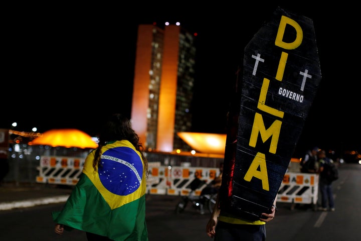 A pro-impeachment demonstrator holds a cardboard coffin painted with the name of Brazil's suspended president Dilma Rousseff during a protest in front of the National Congress, in Brasilia, Brazil, August 30, 2016.