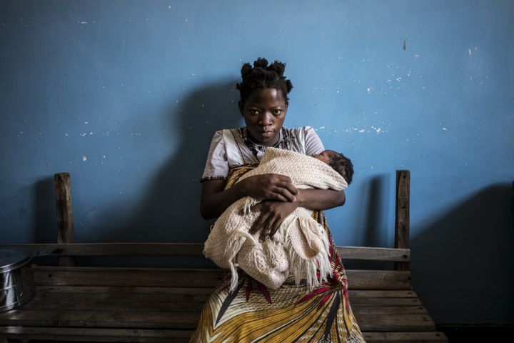 Miriam Thomas, 18, an HIV-positive patient on antiretroviral therapy, holds her second baby as she waits for a medical consultation at the Nsanje District Hospital in Malawi on Nov. 25, 2014, during a routine post-natal visit and antiretroviral assessment.