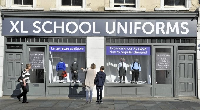 Cancer Research UK has transformed a shop front into an XL school uniform shop to show the new norm of larger school uniforms.