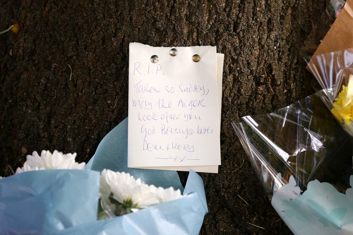 Flowers and a note left in tribute at the scene