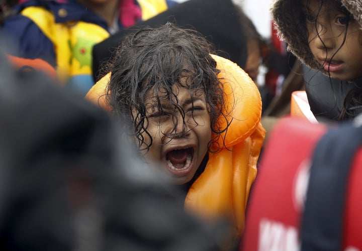 A Syrian refugee child screams inside an overcrowded dinghy after crossing part of the Aegean Sea from Turkey to the Greek island of Lesbos on Sept. 23, 2015.